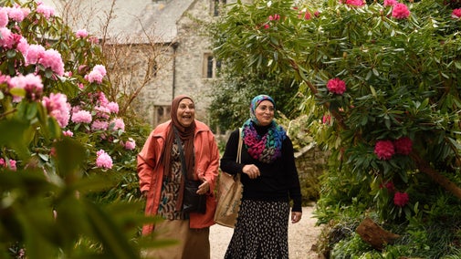 Visitors exploring the garden in spring at Cotehele, Cornwall